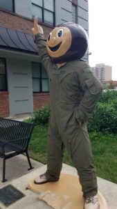 Larger than life size Ohio State University "Bucky" mascot statue dressed in green military flight suit outside The Ohio State University ROTC building.