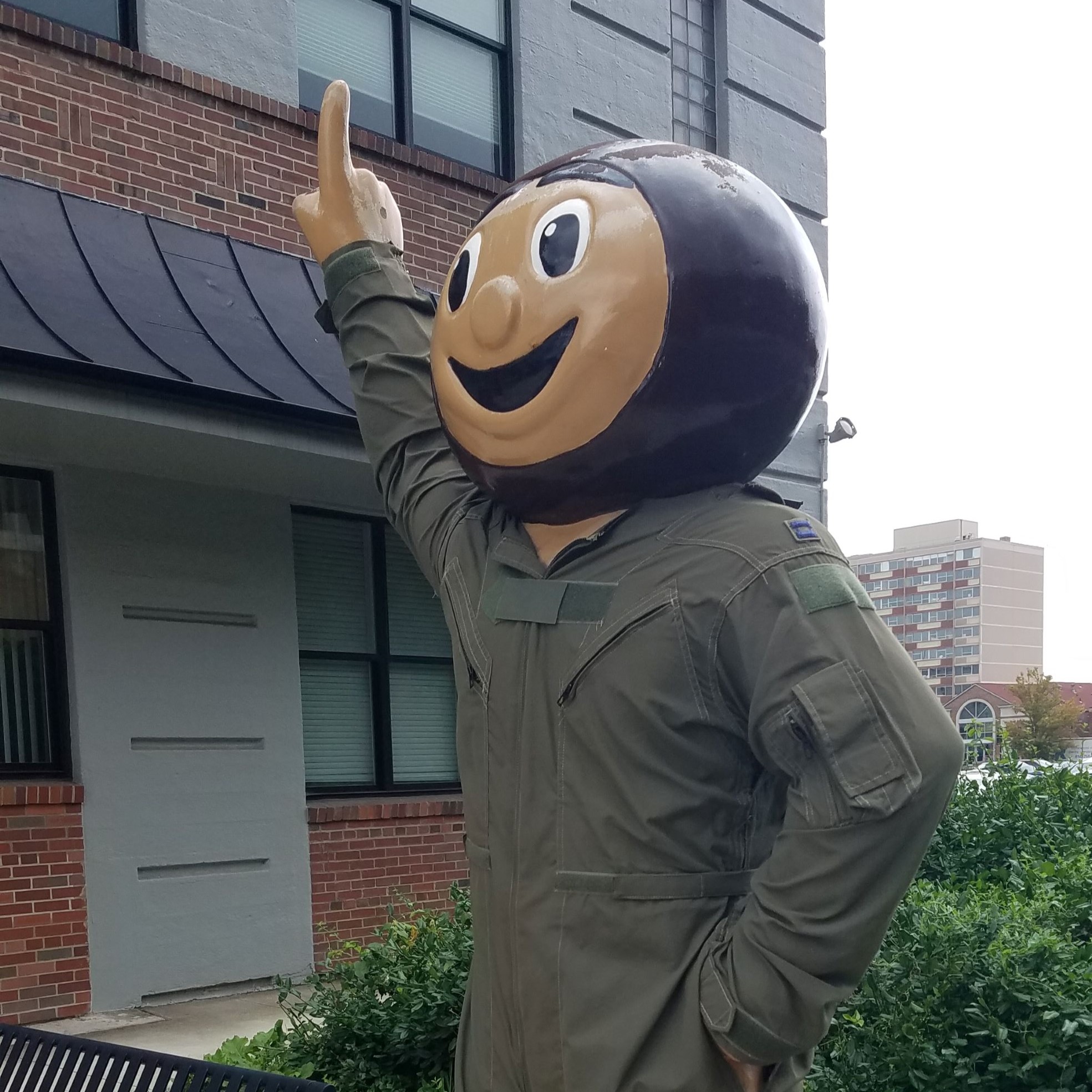 Larger than life size Ohio State University "Bucky" mascot statue dressed in green military flight suit outside The Ohio State University ROTC building.