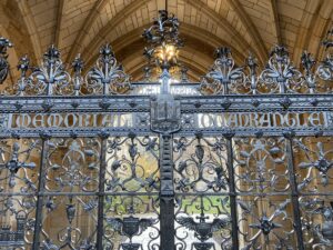 Black wrought iron gate for the Memorial Quadrangle at Yale University, which incorporates symbols of the Army and Navy from World War One. 