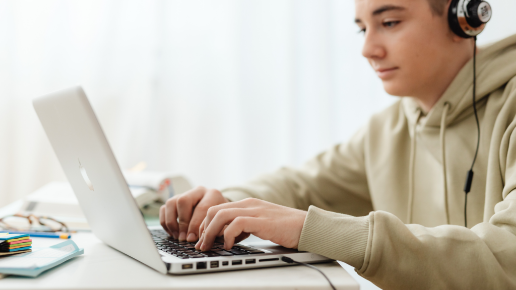 Teen male working on Common Application on laptop