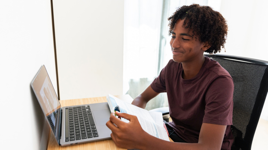 Young teen boy working on Zoom call on laptop